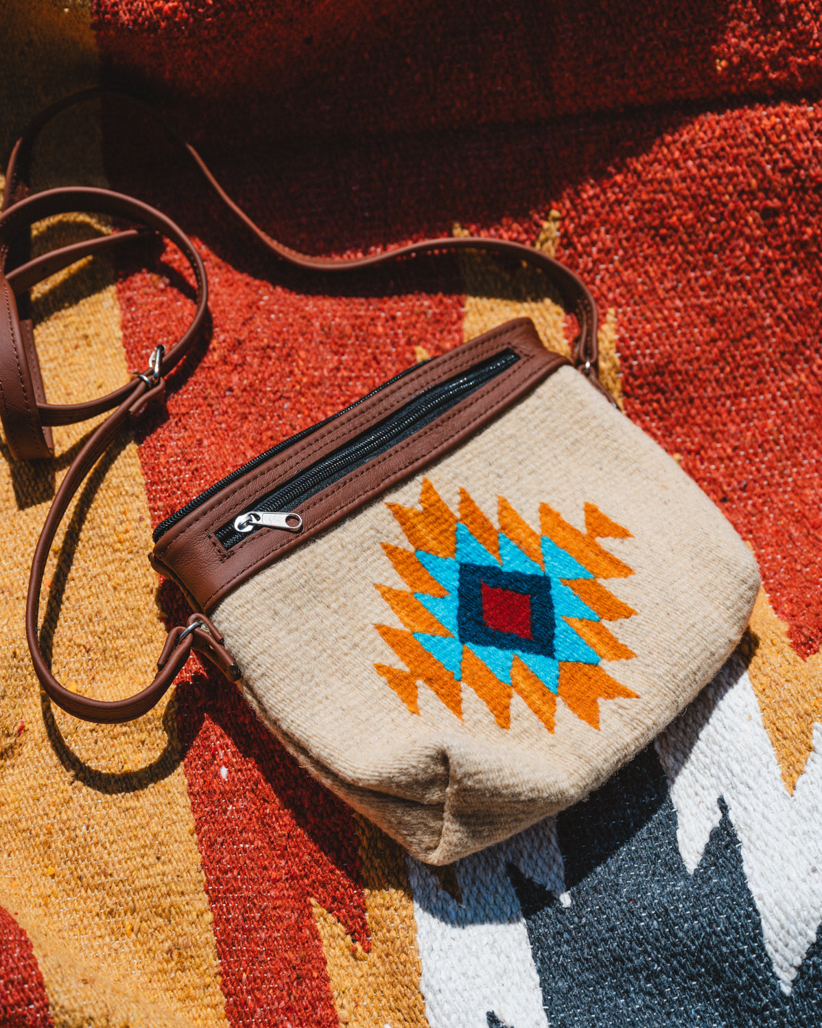 handwoven wool zapotec purse laying on mexican blanket