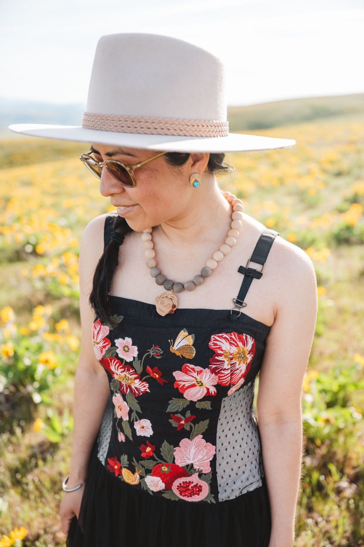 Woman wearing a clay catrina necklace from oaxaca