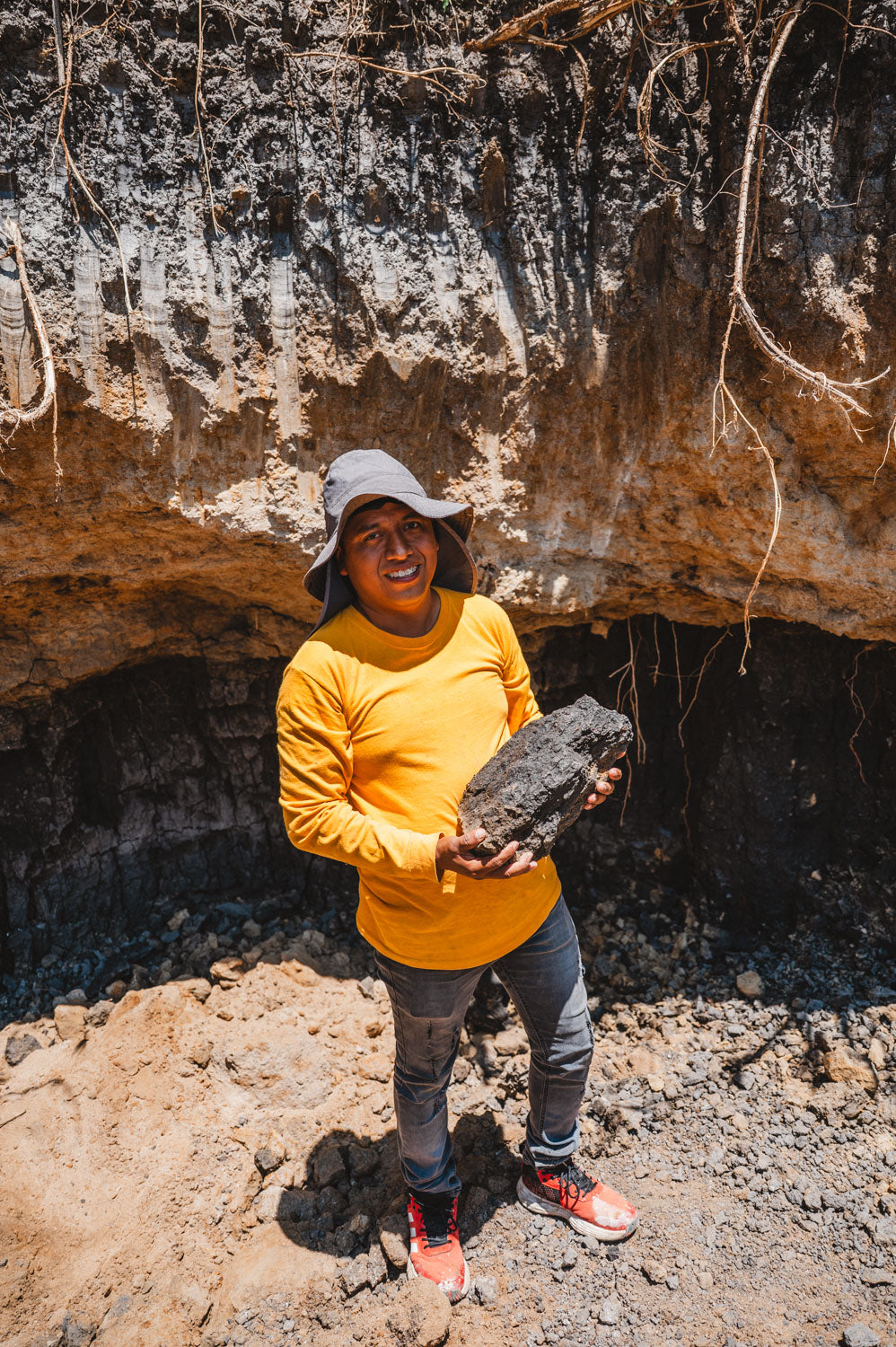 Potter holding barro negro or black clay from the clay mine in oaxaca