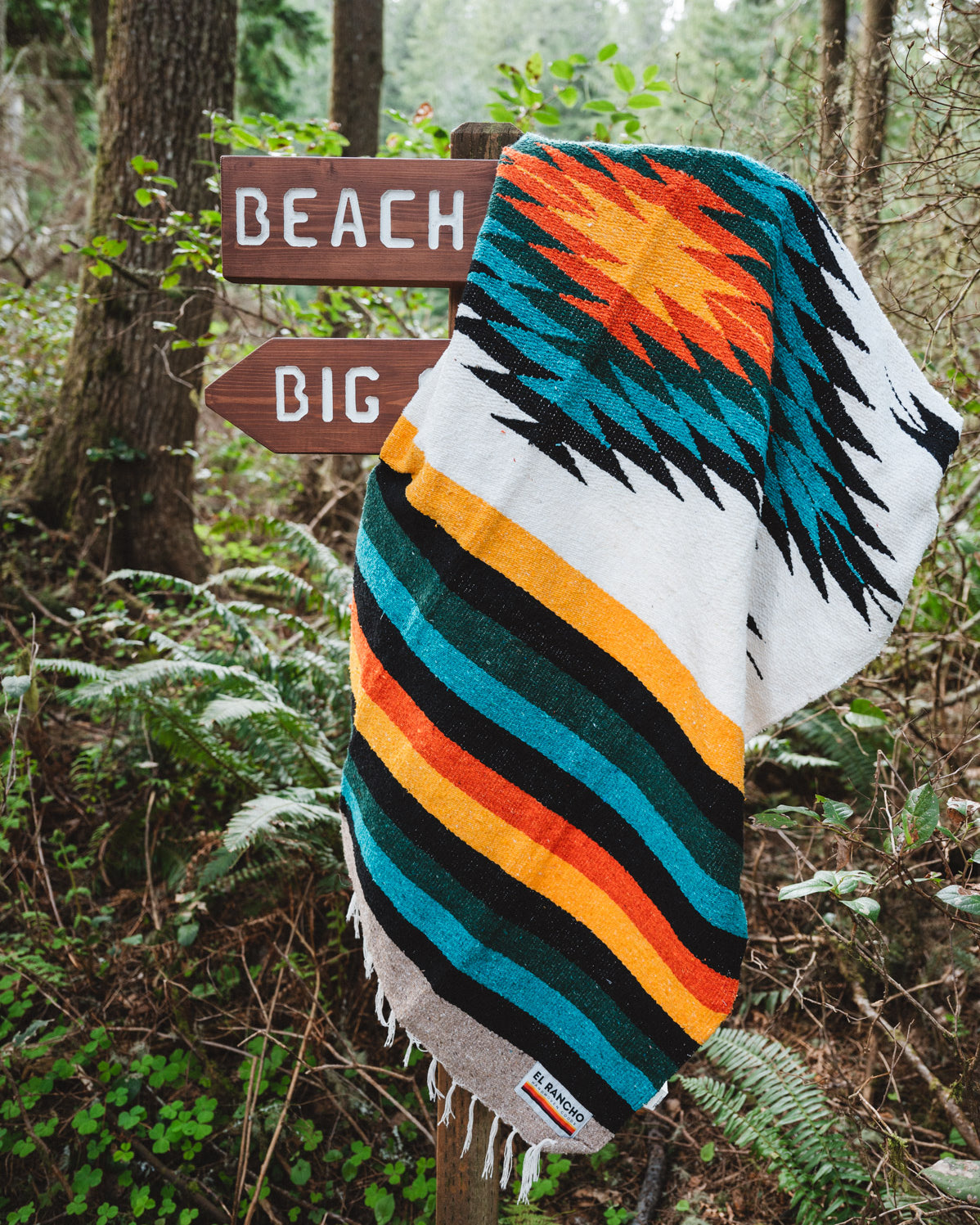 handwoven mexican blanket hanging on trail sign