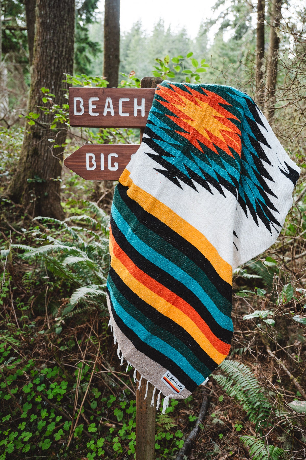 handwoven mexican blanket hanging on trail sign