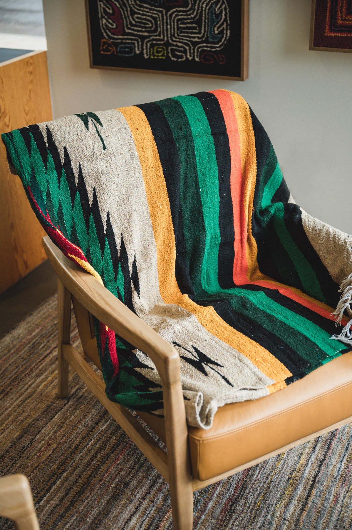 chair wrapped with multi color diamond handwoven mexican blanket