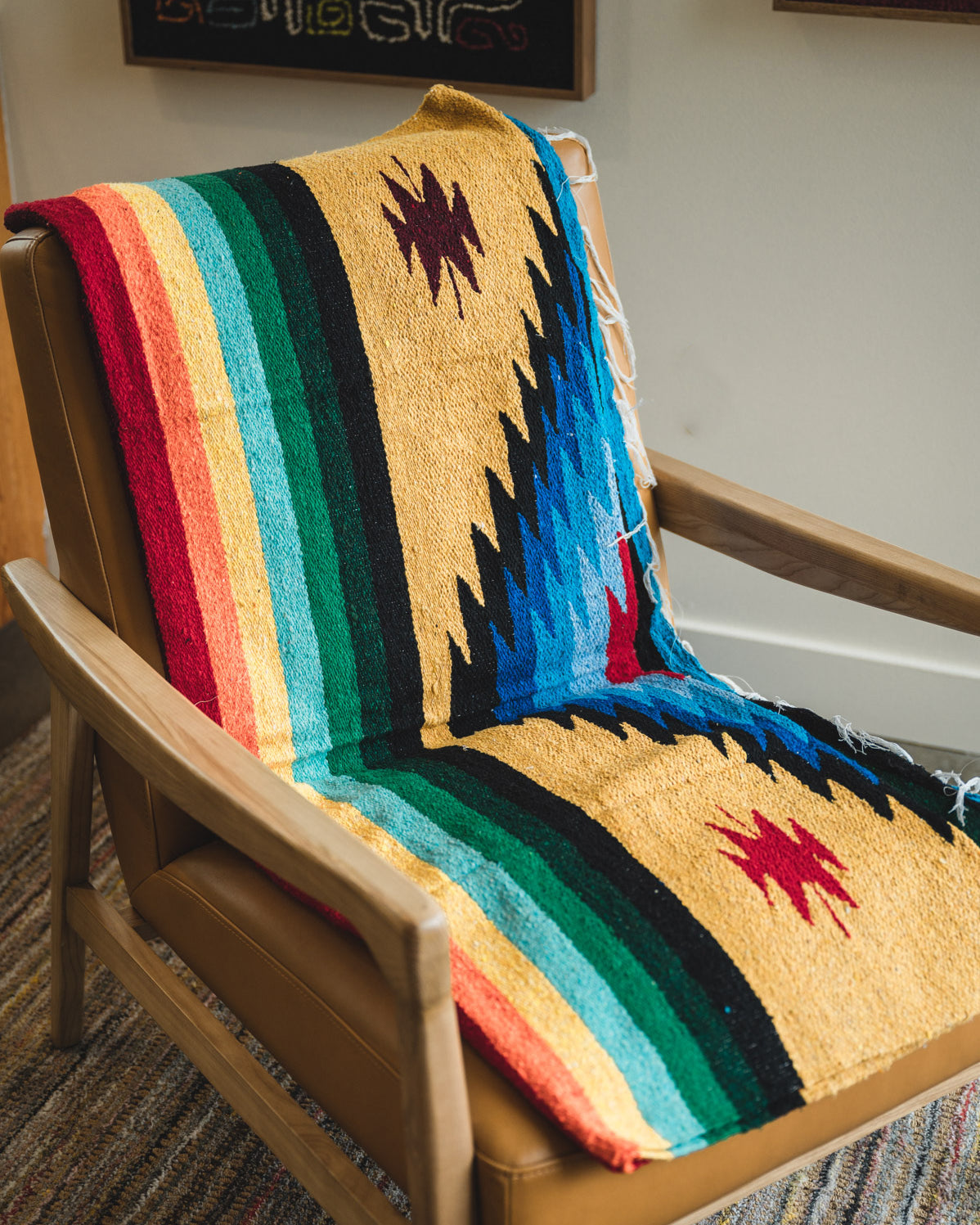 folded diamond pattern mexican blanket on a chair
