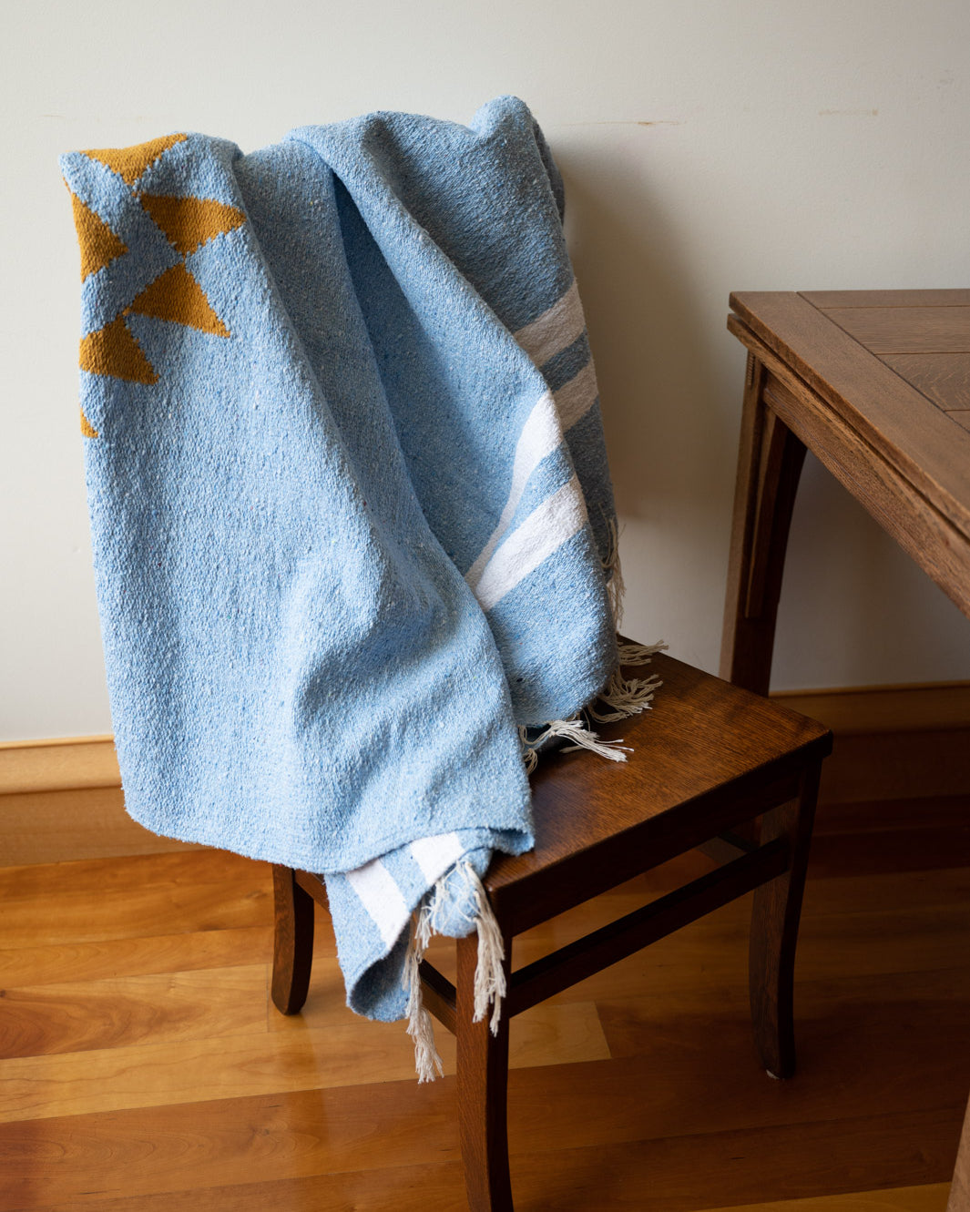 blue mexican blanket on a chair