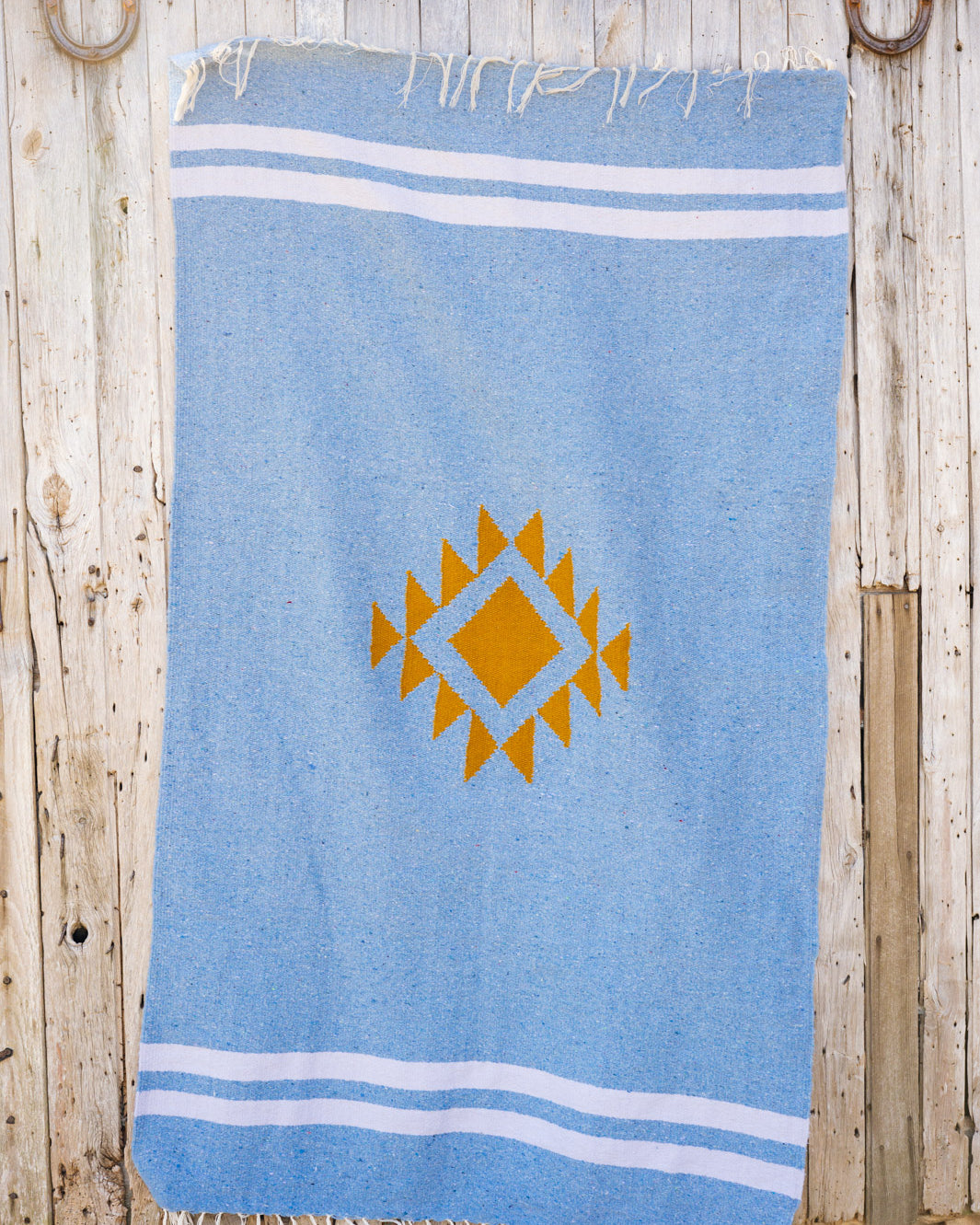 Blue mexican blanket on a barn door