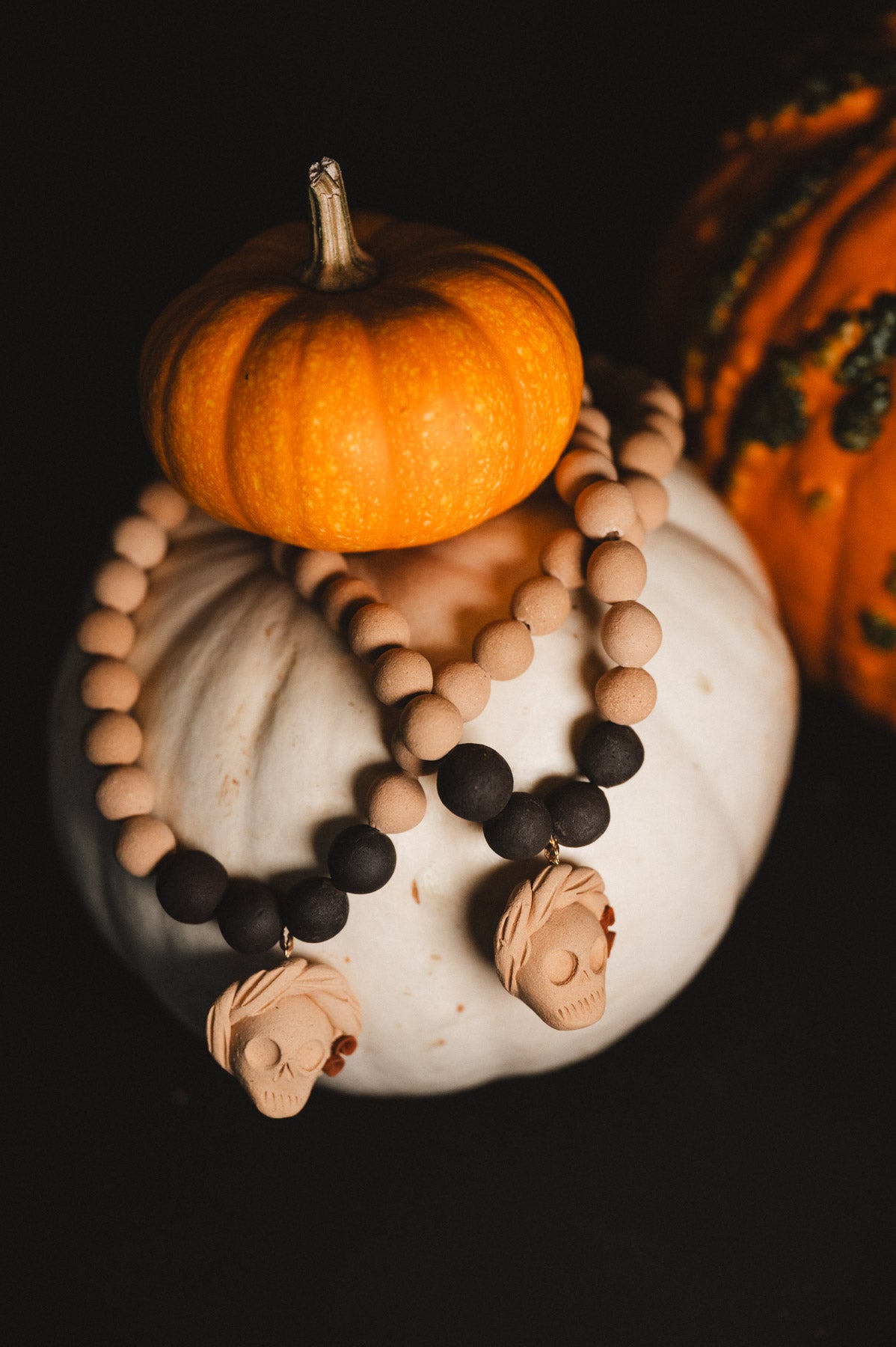 Decorative necklace with pumpkins on a dark background