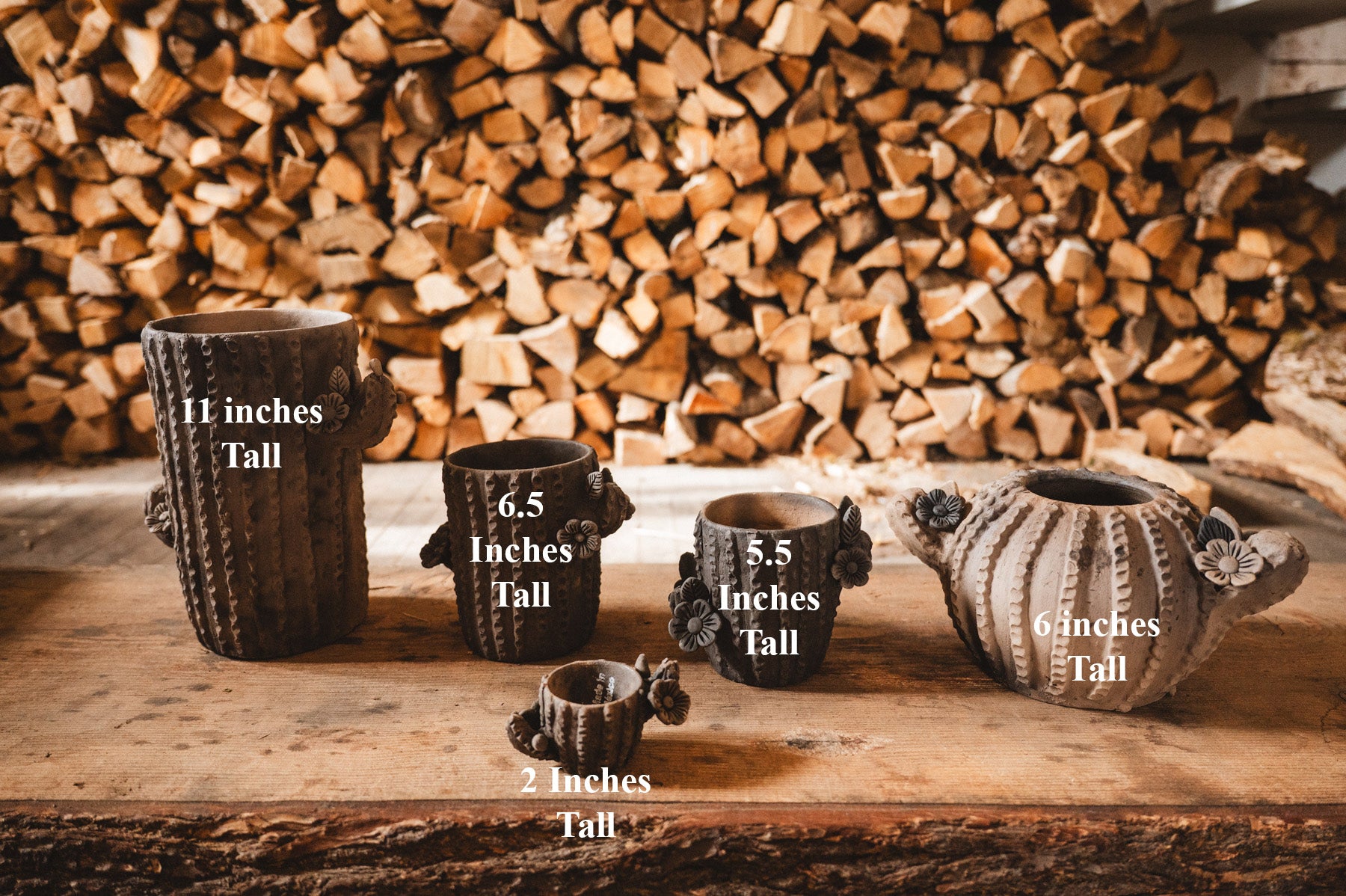 Set of ceramic pots with height measurements against a wooden background