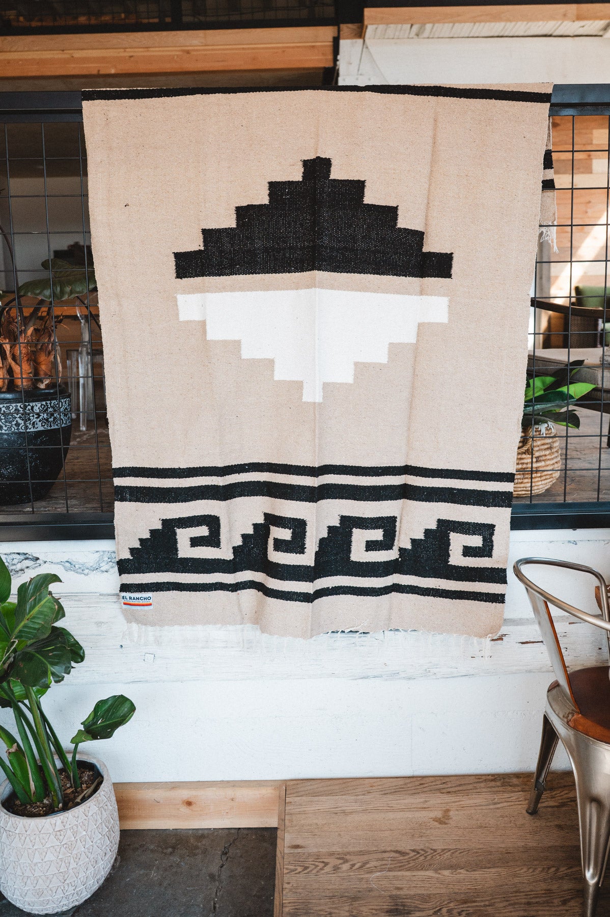 Handwoven Mexican Blanket beige Mixteca Greca  pattern in modern industrial setting