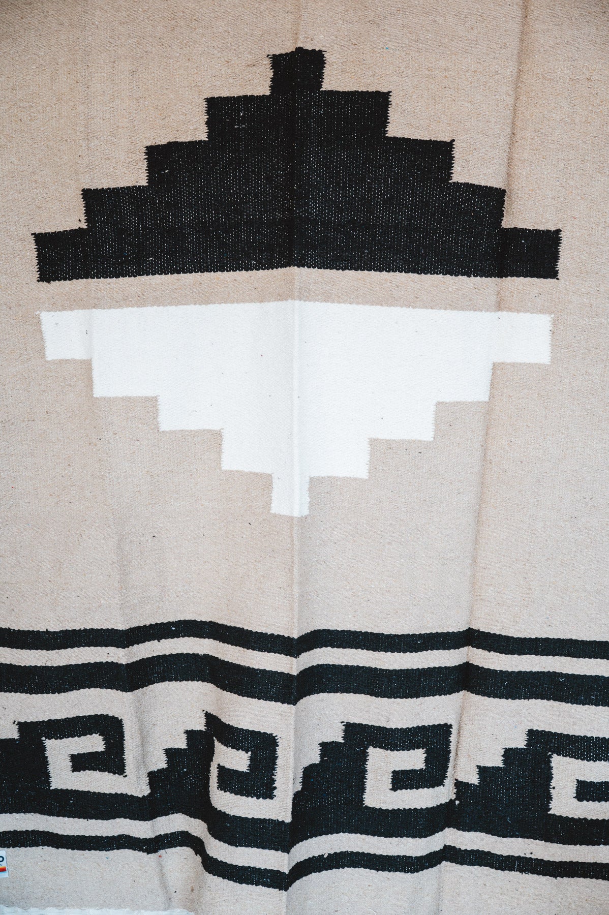 Handwoven Mexican Blanket beige Mixteca Greca  pattern in modern industrial setting