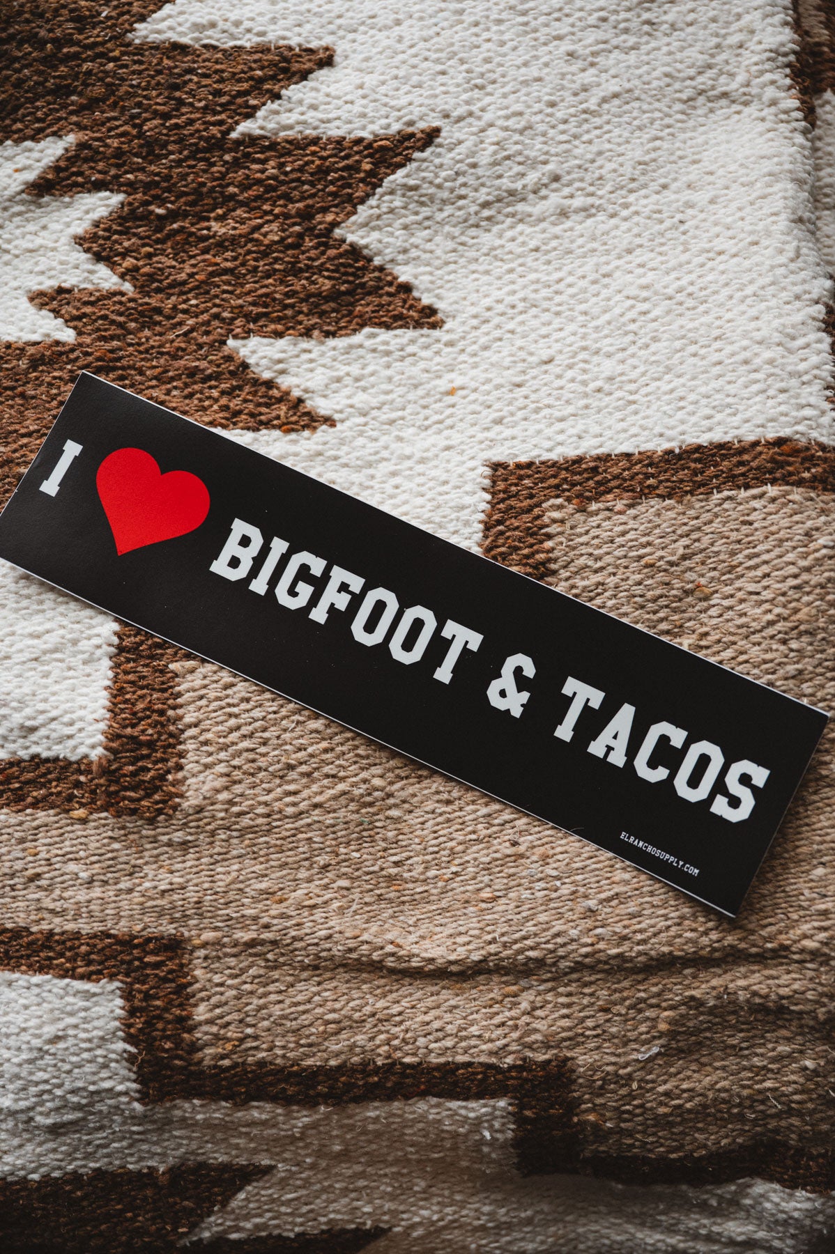Bigfoot and tacos bumper sticker on a mexican blanket
