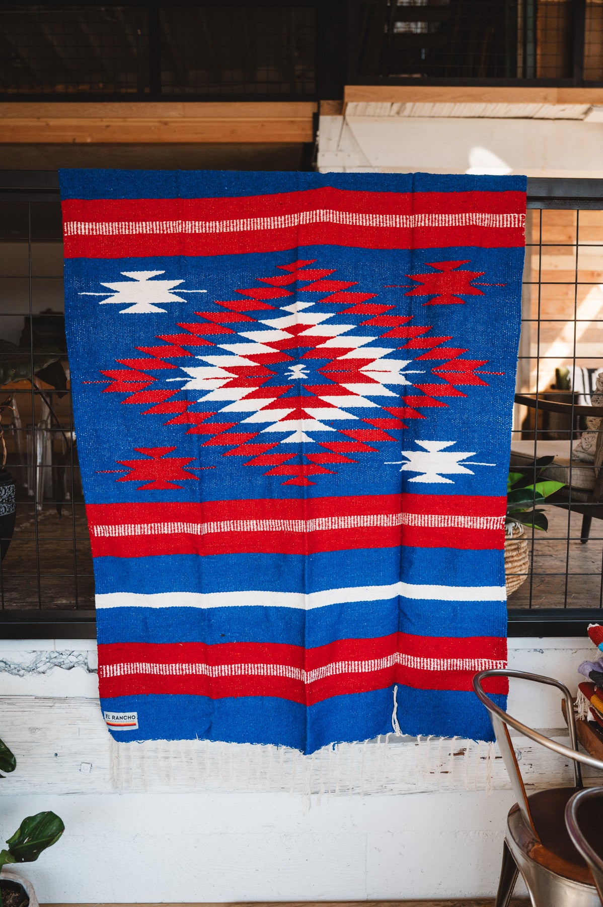 Handwoven Mexican Blanket Buffalo USA color Diamond pattern in modern industrial setting
