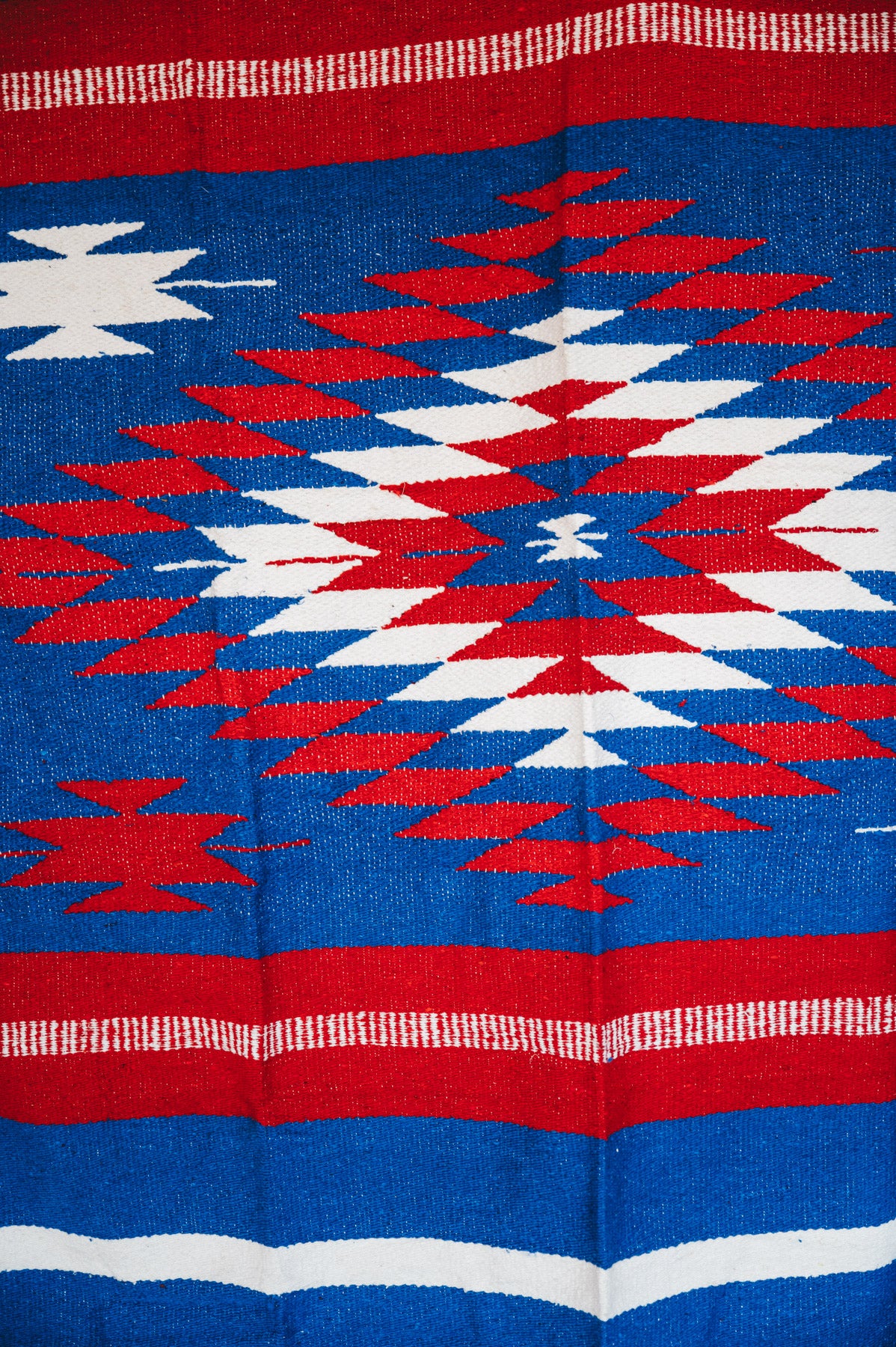 Handwoven Mexican Blanket Buffalo USA color Diamond pattern in modern industrial setting