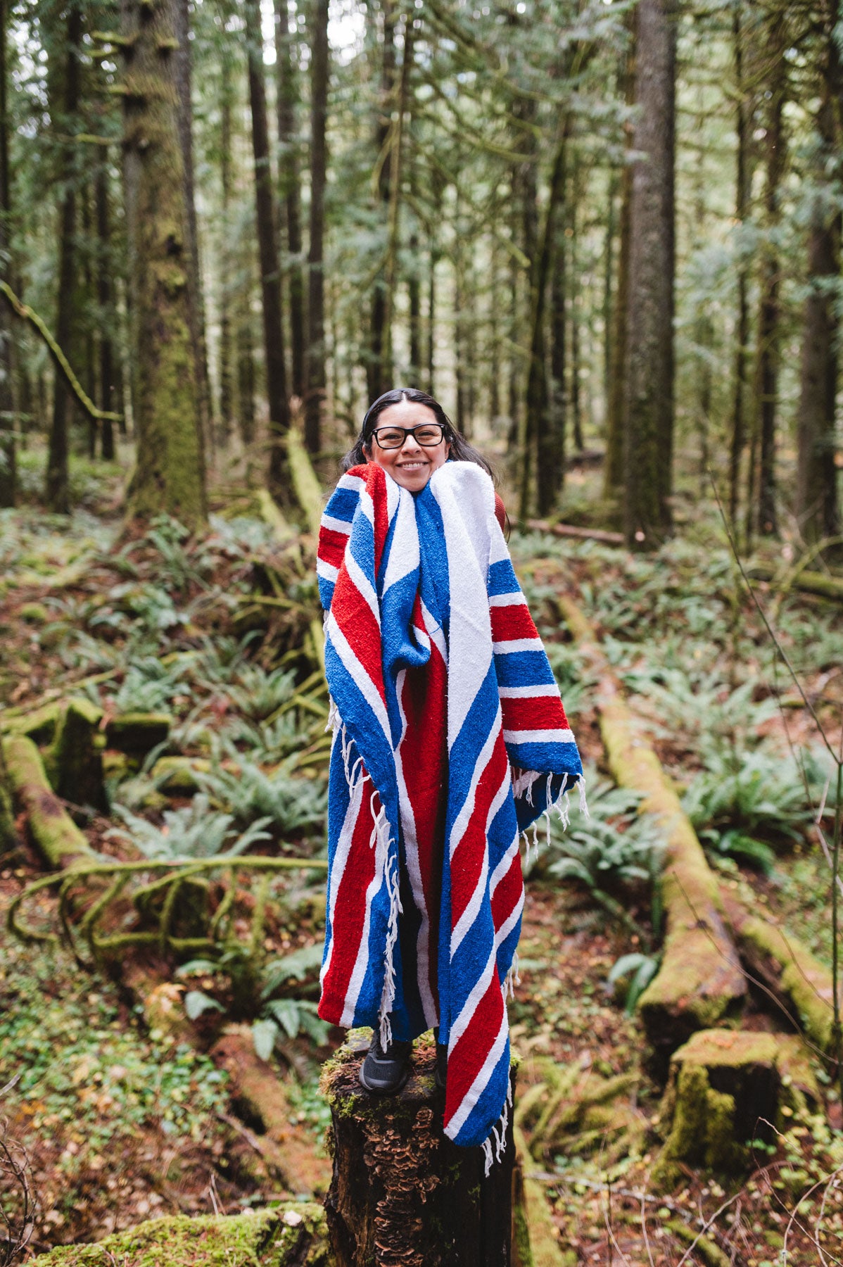 Buffalo Bills blanket wrapped around woman in forest