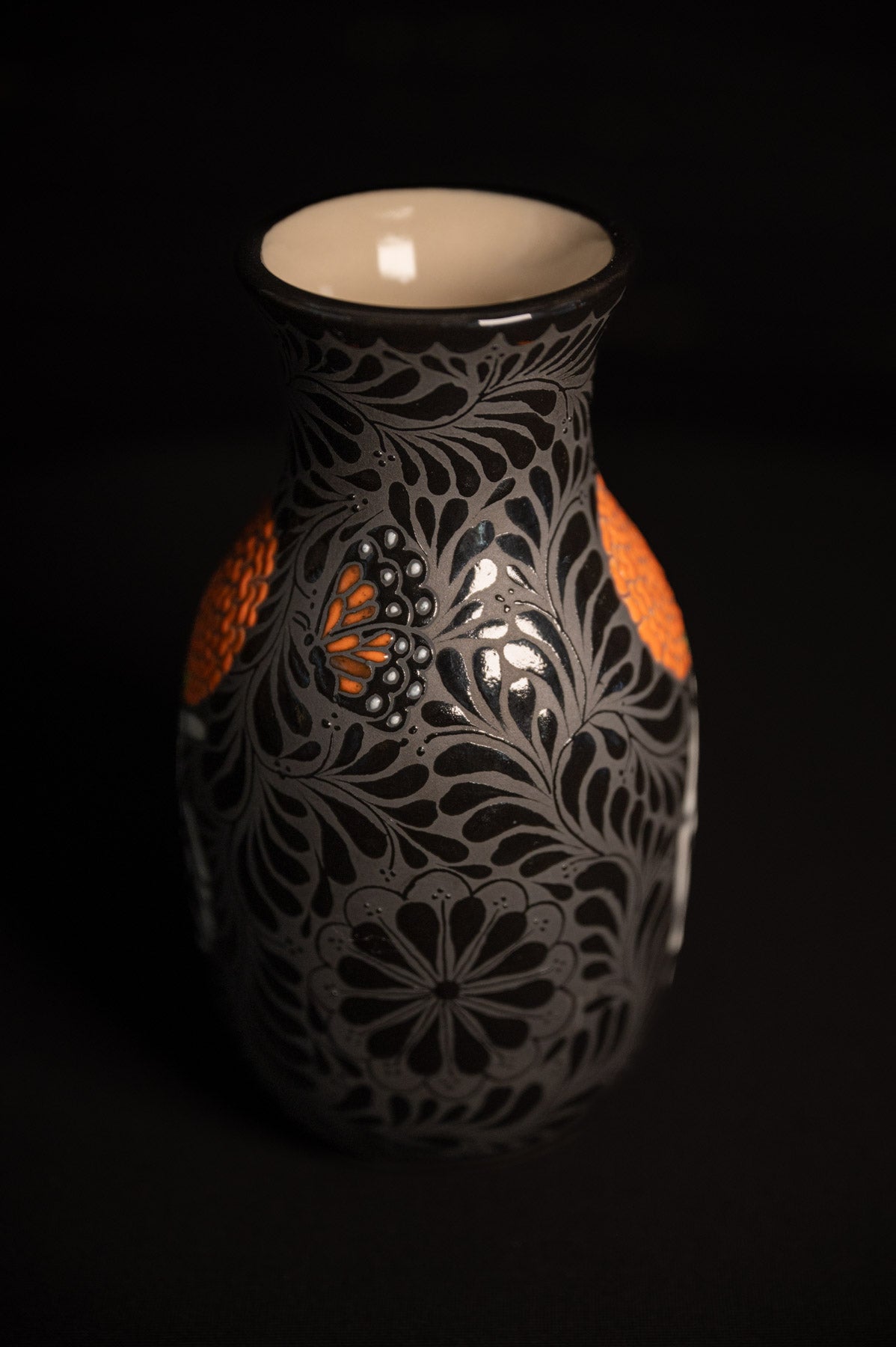 Day of the dead talavera vase featuring monarch and skeleton hand holding a marigold