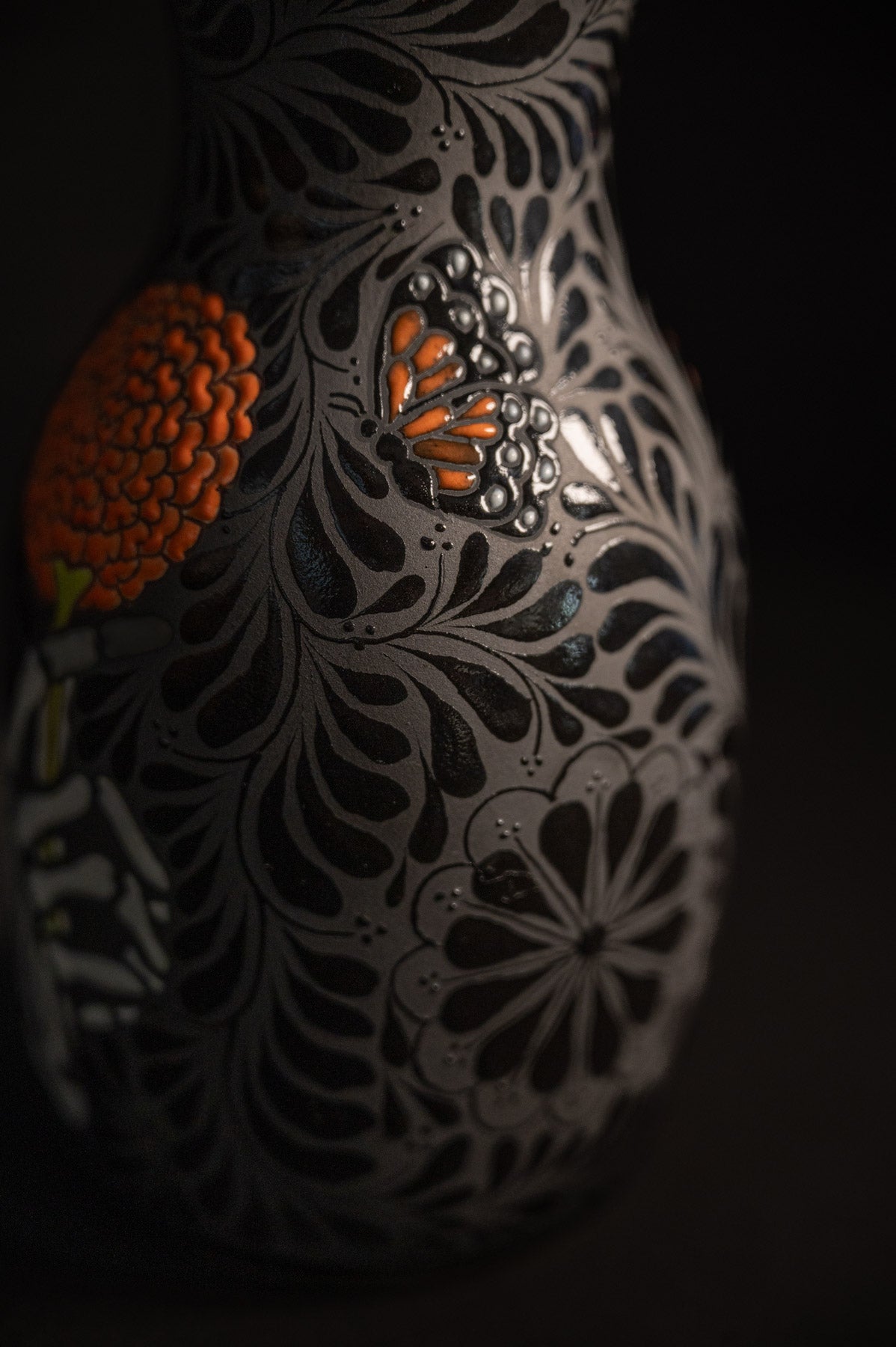 Day of the dead talavera vase featuring monarch and skeleton hand holding a marigold