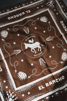 Brown bandana with white patterns and 'El Rancho' branding