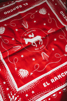 Red bandana with white patterns and 'El Rancho' branding