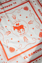 White fabric with red 'El Rancho' branding and illustrations