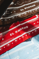 Two bandanas with 'El Rancho' branding on a blue background