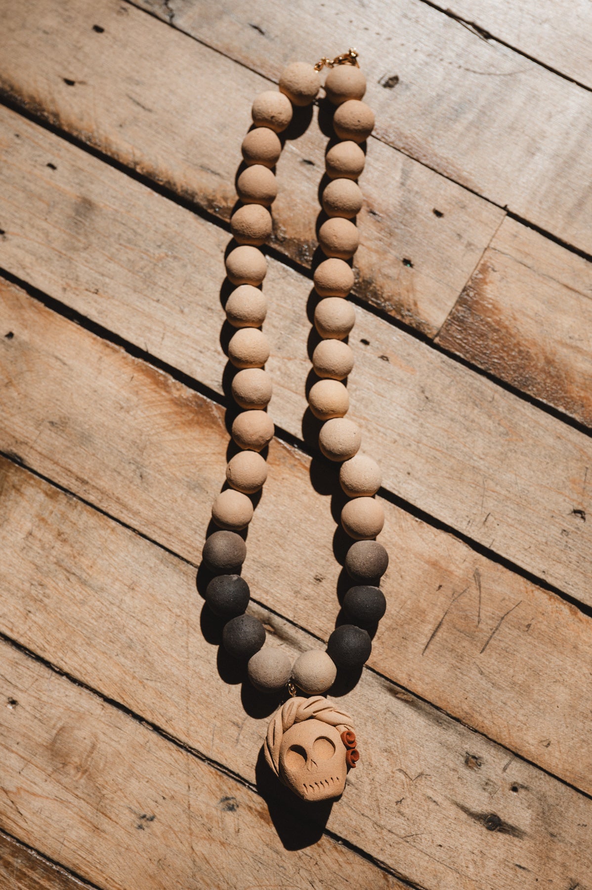 Barro negro catrina necklace on wooden background