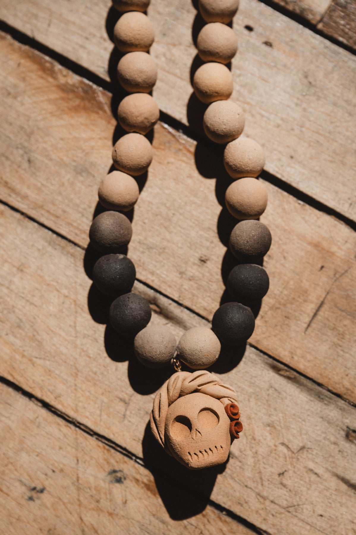 Barro negro catrina necklace on wooden background