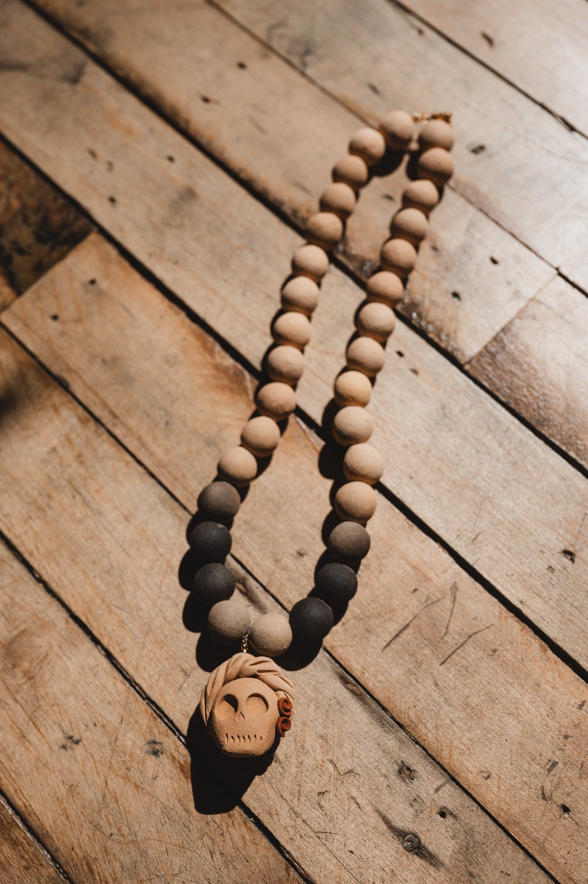 Barro negro catrina necklace on wooden background