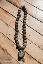 Barro negro catrina necklace on wooden background