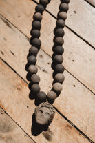 Barro negro catrina necklace on wooden background
