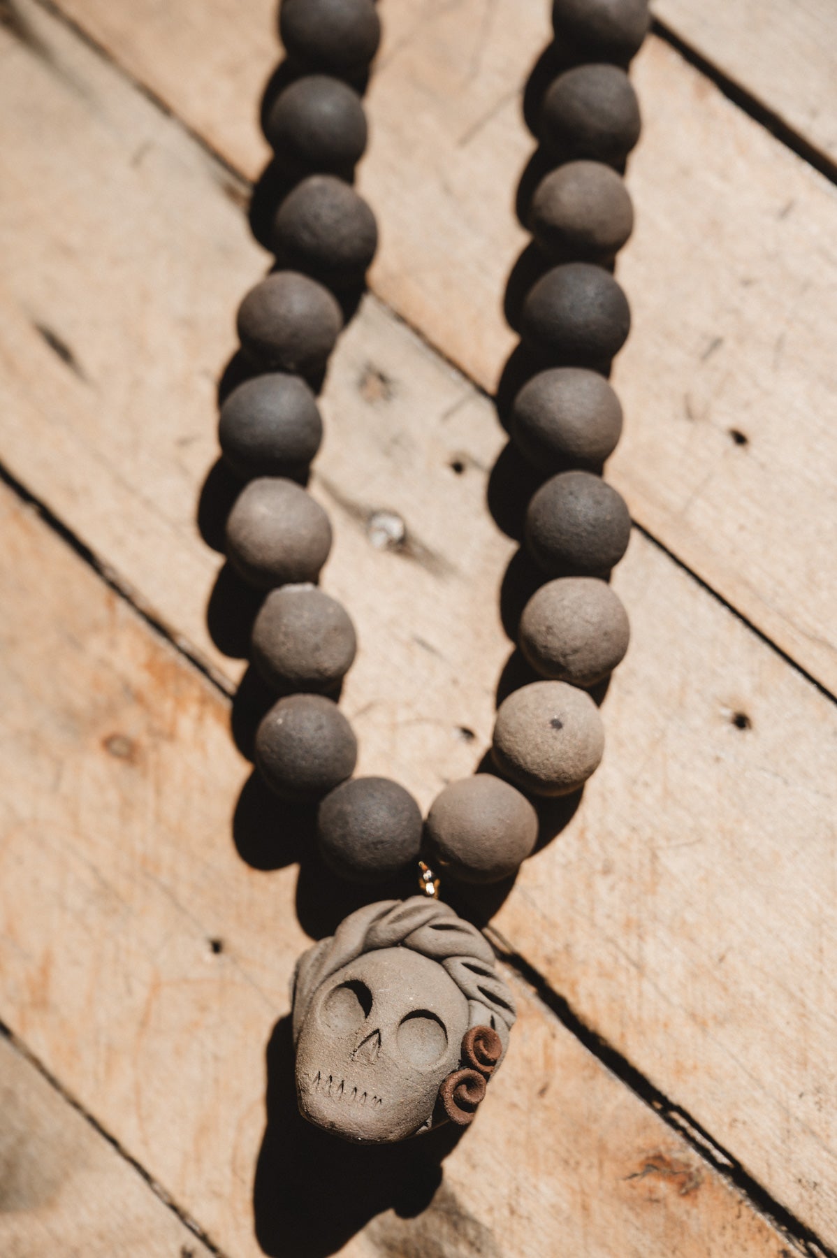 Barro negro catrina necklace on wooden background