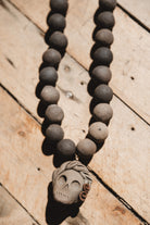 Barro negro catrina necklace on wooden background