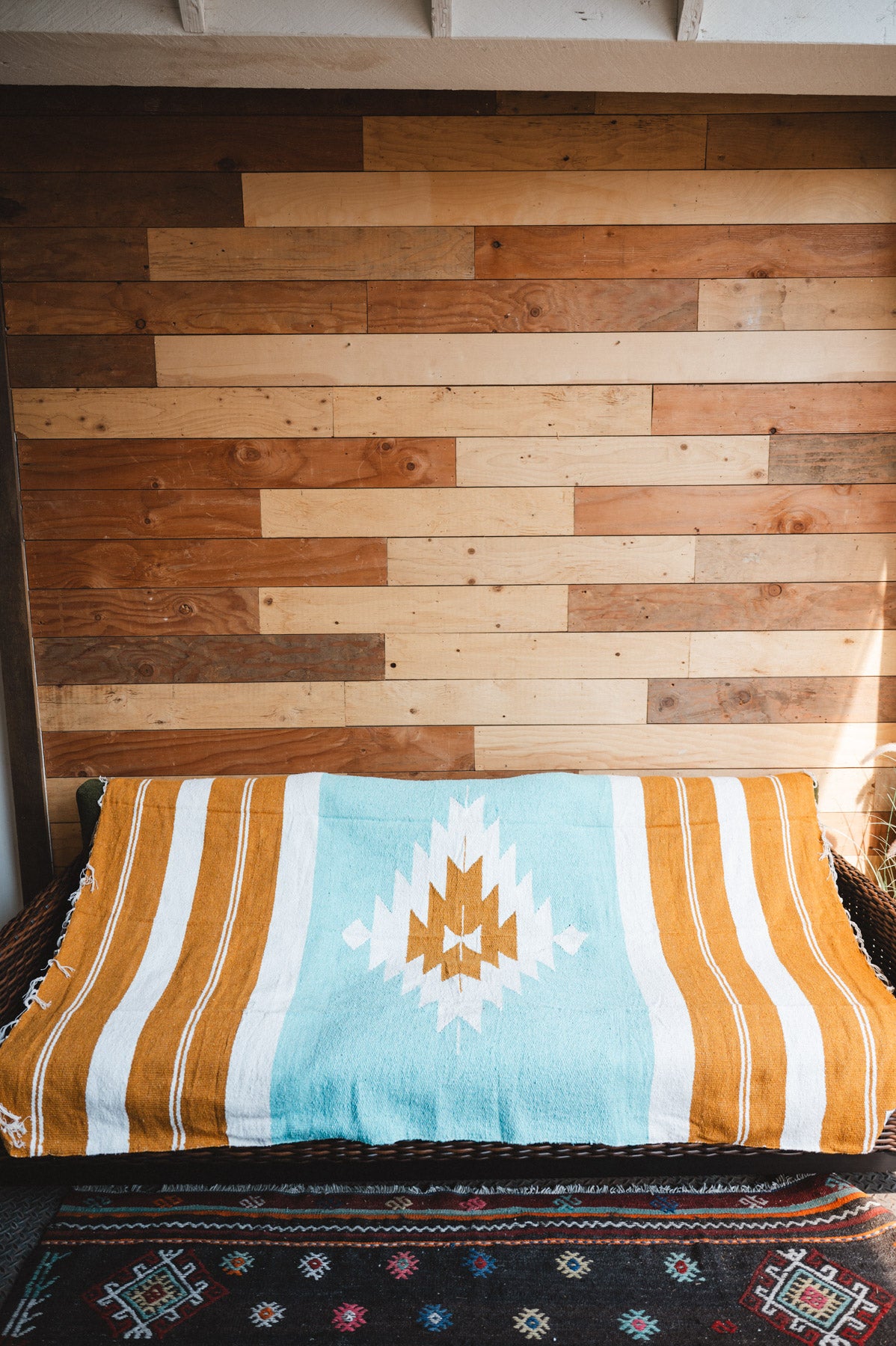 andwoven Mexican Blanket Turquoise and gold color Diamond pattern in modern industrial setting