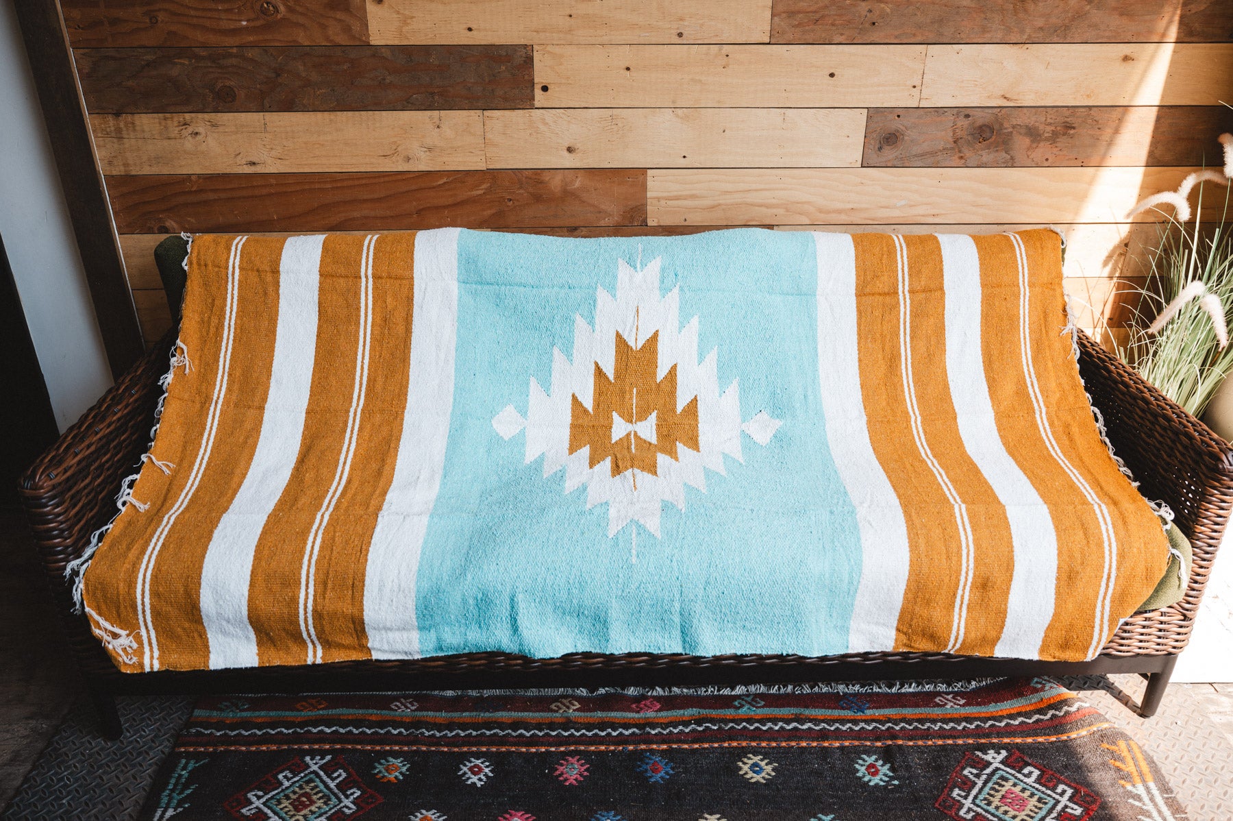 Handwoven Mexican Blanket Turquoise and gold color Diamond pattern in modern industrial setting