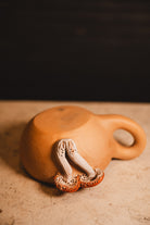 clay mushroom coffee mug on white counter