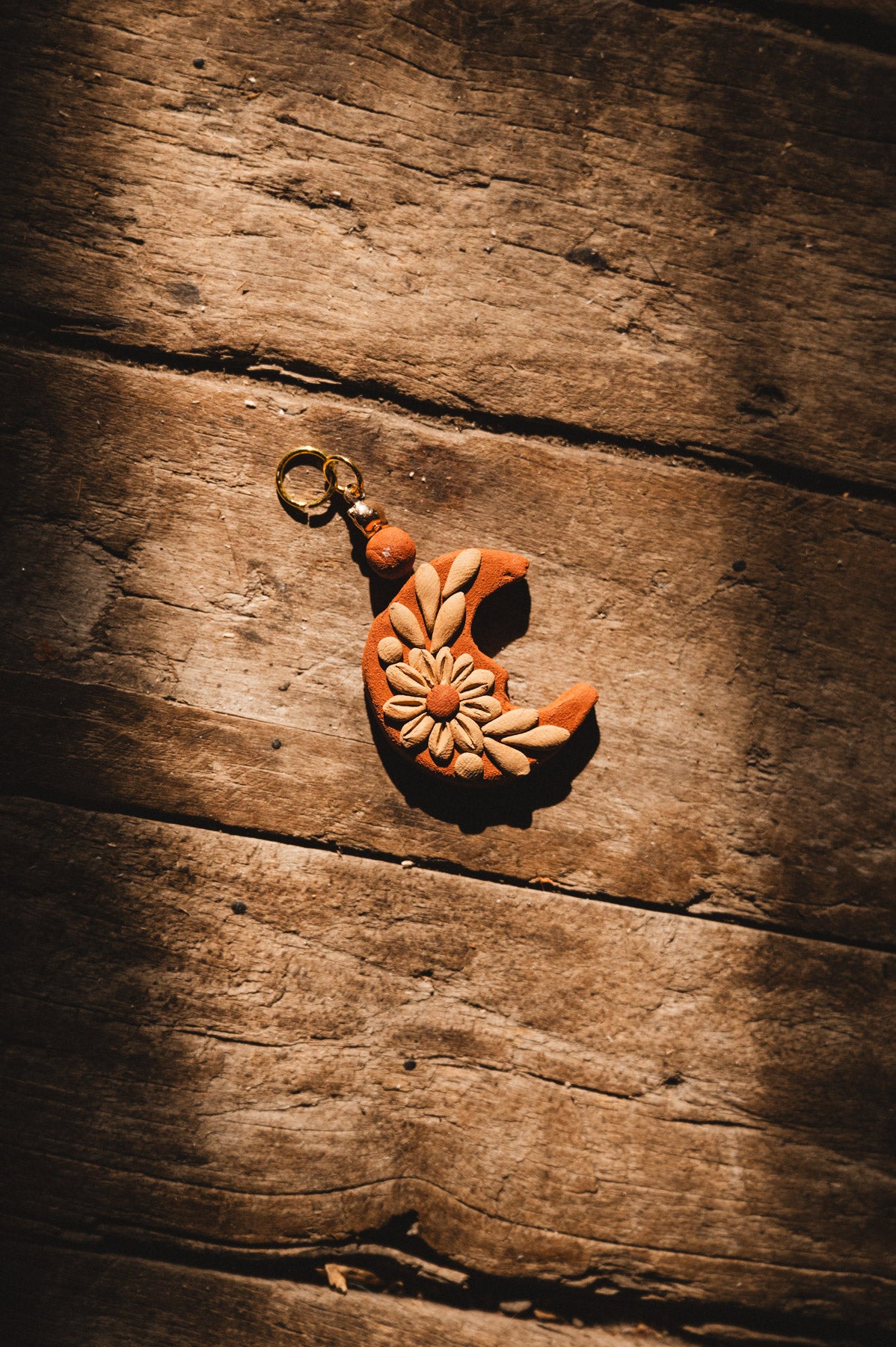 Handmade Filigrana Oaxacan Moon Pendant on wood background