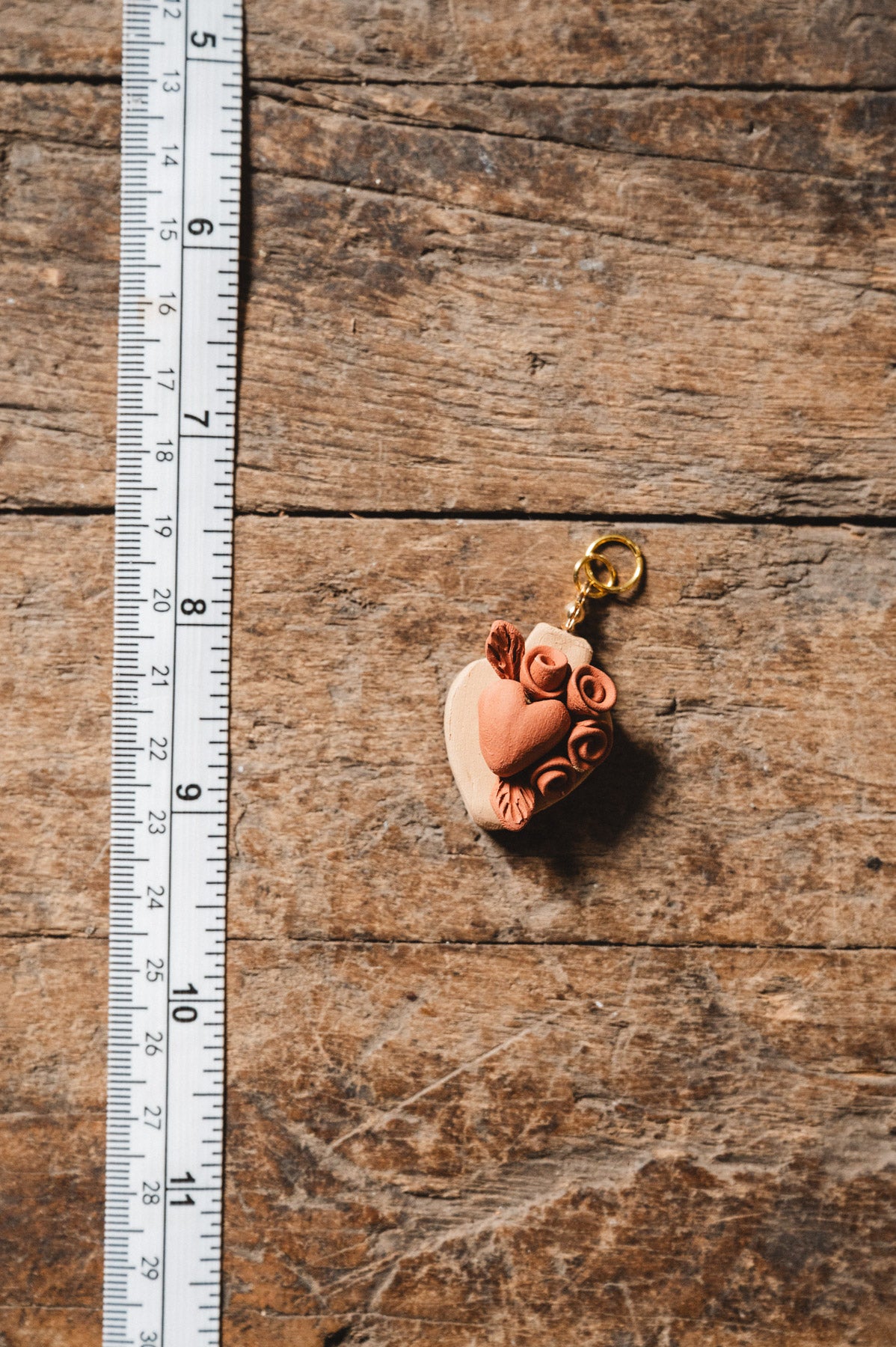 Small decorative item on a wooden surface with a ruler for scale.