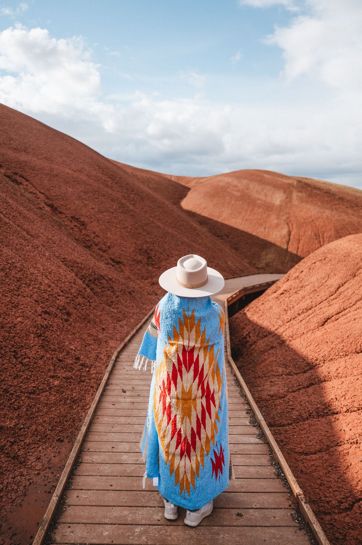 Painted Hills Oregon with a woman wearing a blue mexican blanket