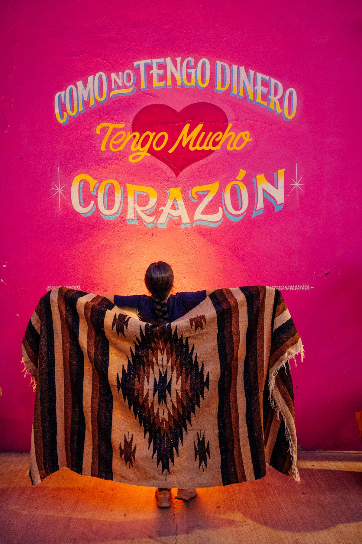 Brown mexican blanket against a pink wall