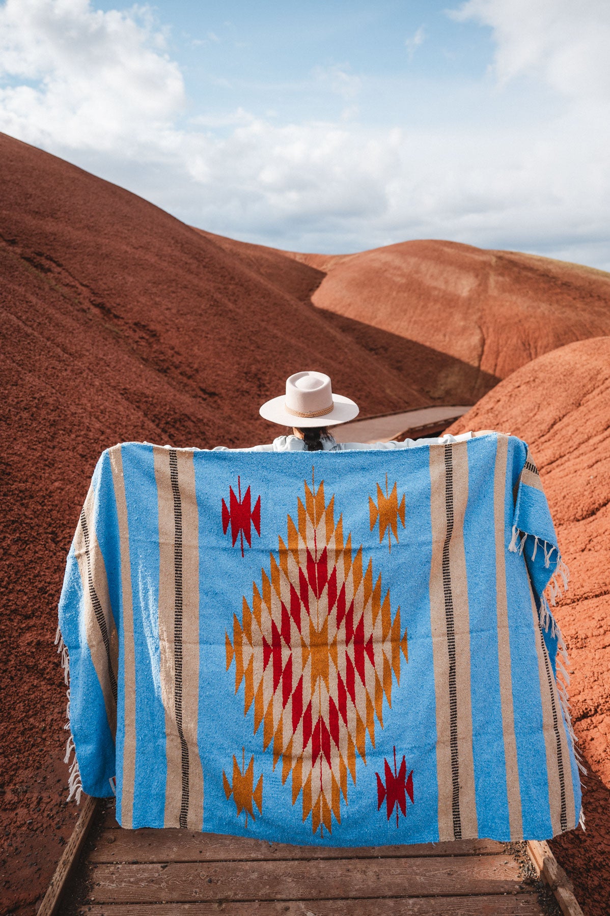 Painted Hills Oregon with a woman wearing a blue mexican blanket