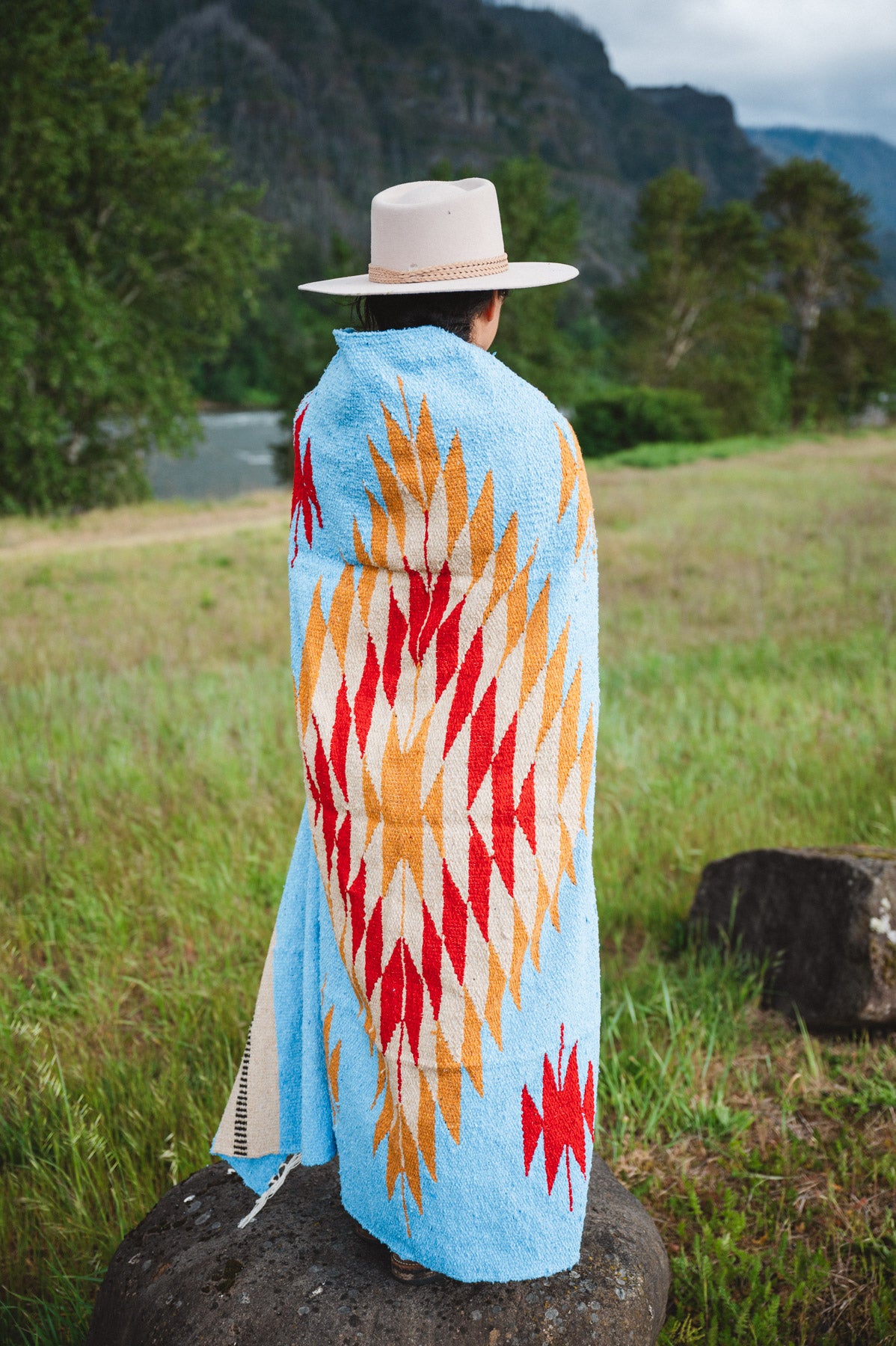 Mexican woman wrapped in blue handwoven mexican blanket