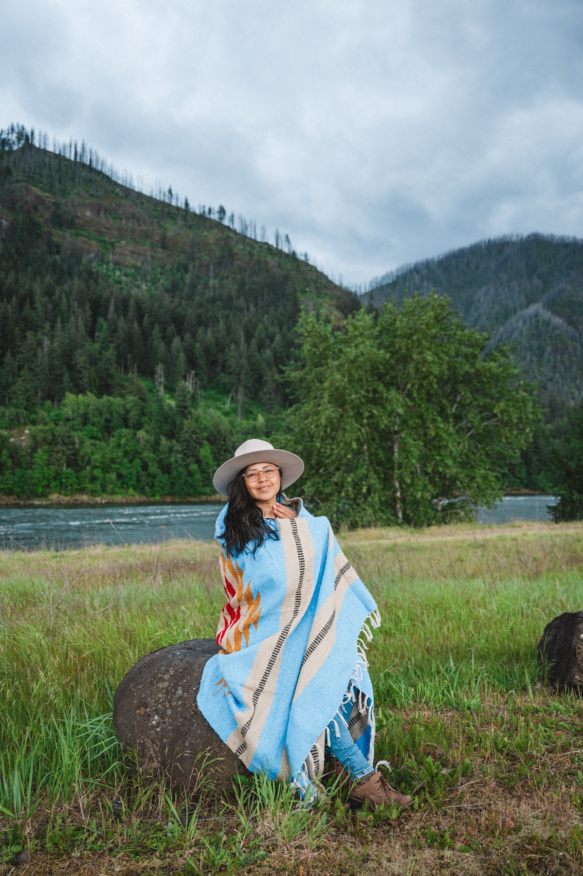 Mexican woman wrapped in blue handwoven mexican blanket