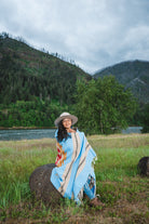 Mexican woman wrapped in blue handwoven mexican blanket