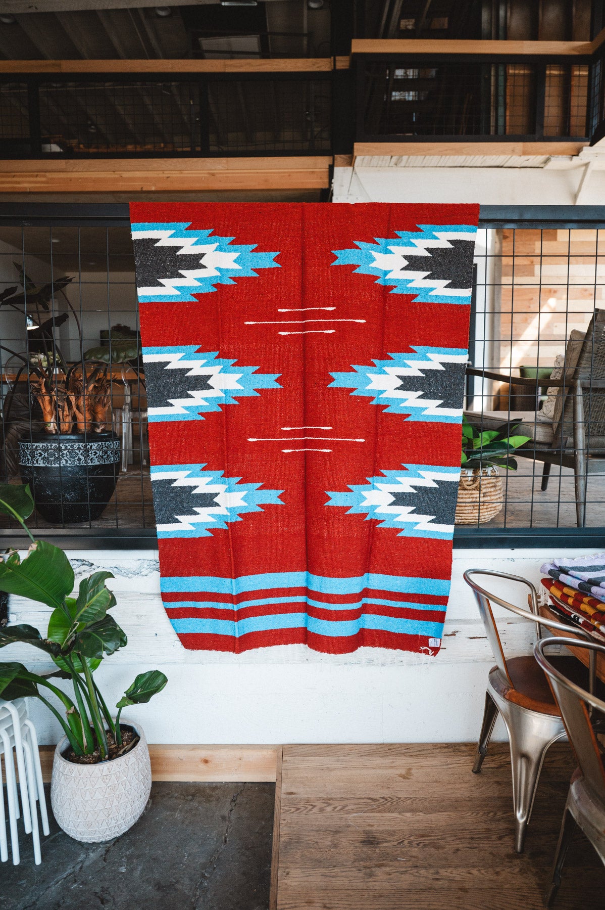 Handwoven Mexican Blanket Red, blue and black Relampago pattern in modern industrial setting