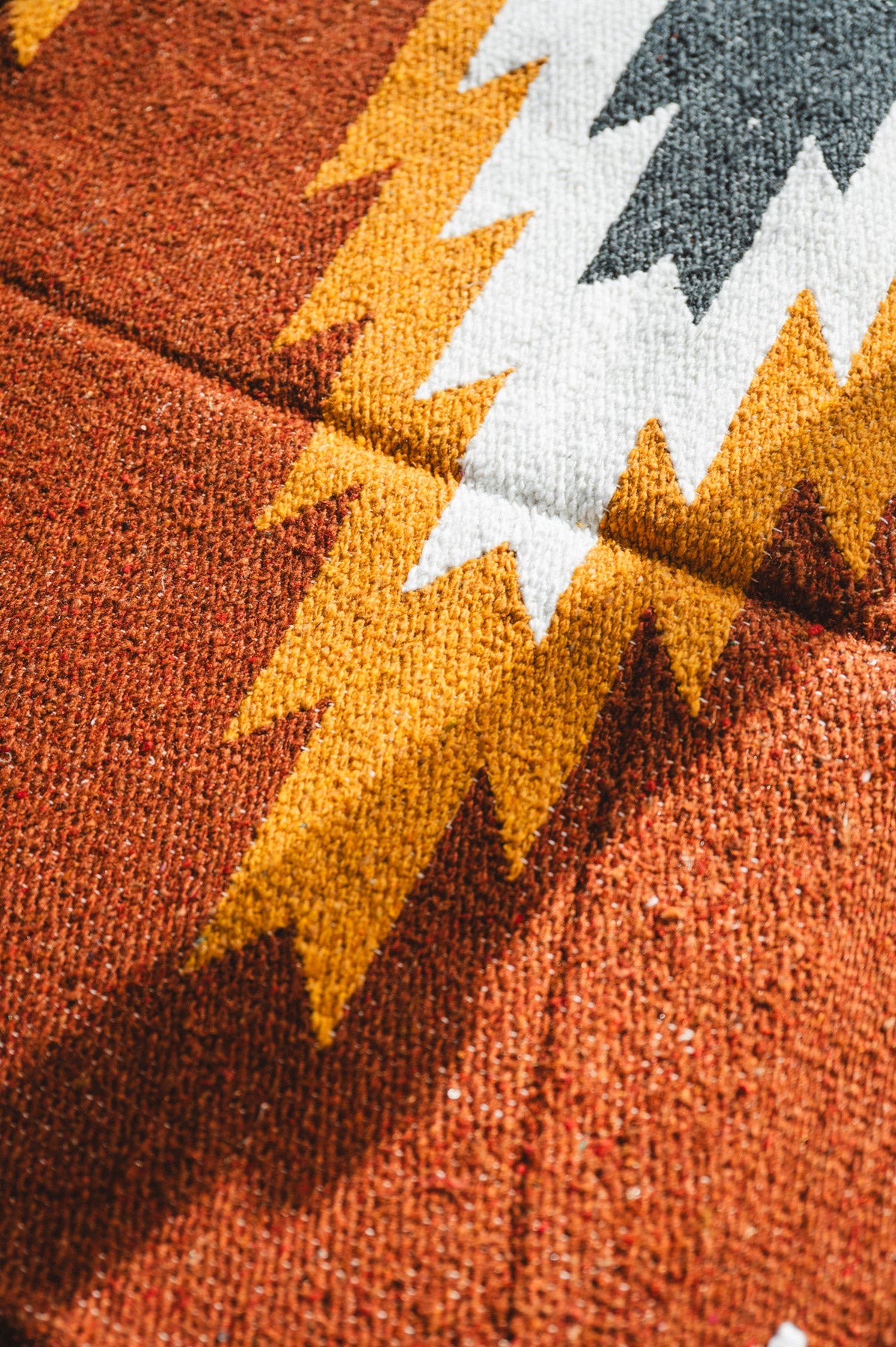 Close-up of a textured fabric with autumn leaf pattern