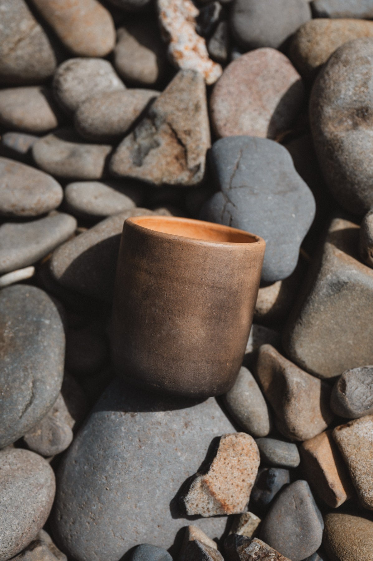 Rustic oaxacan barro negro coffee cup on rocks