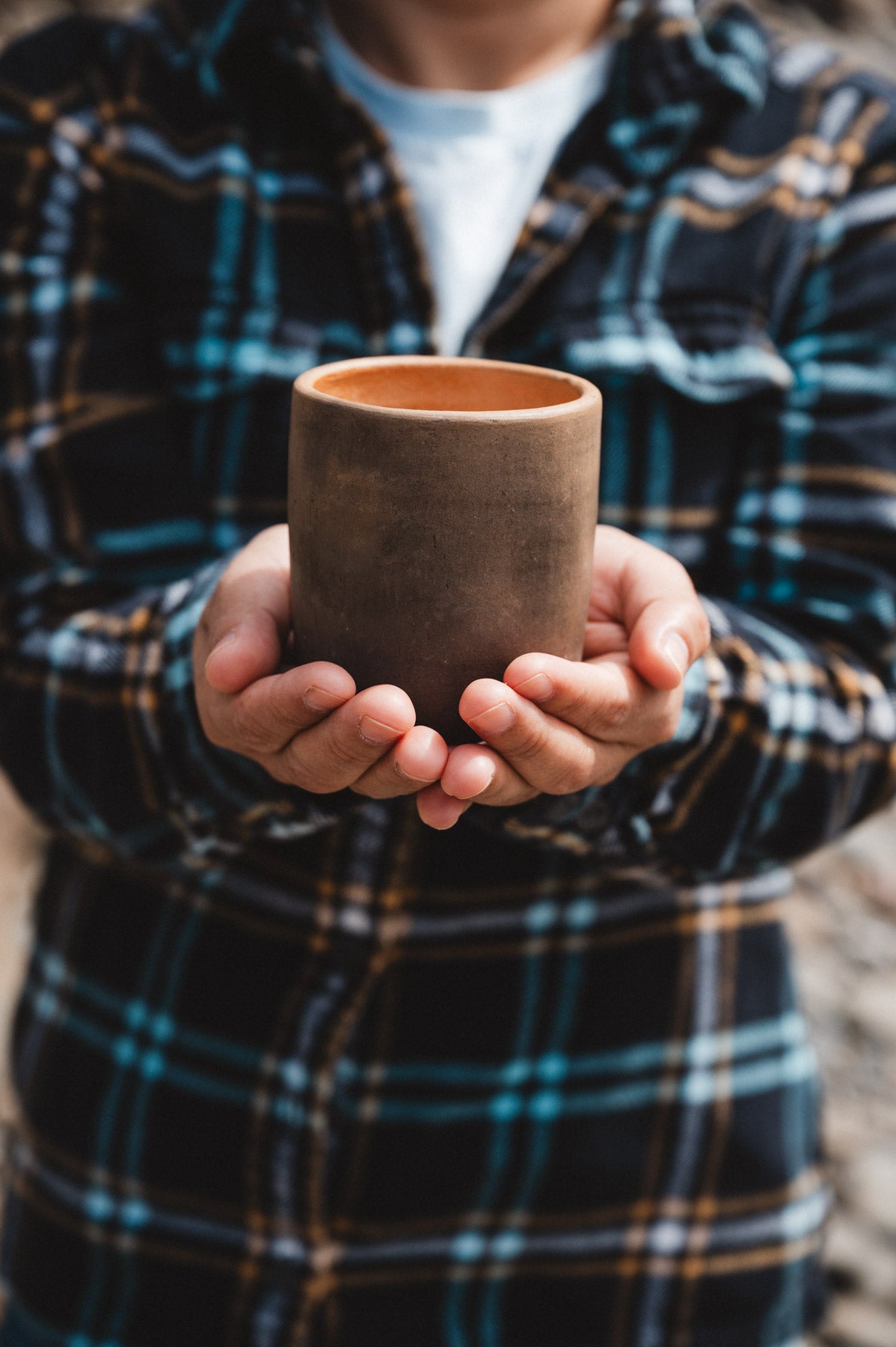 rustic oaxacan barro negro coffee cup held in hands