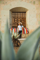 Santo Domingo Church Oaxaca and a girl sitting on a handwoven mexican blanket in front of it