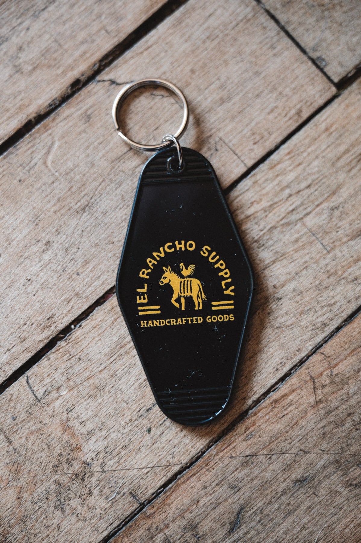 Retro Motel Keychain on wooden Floor